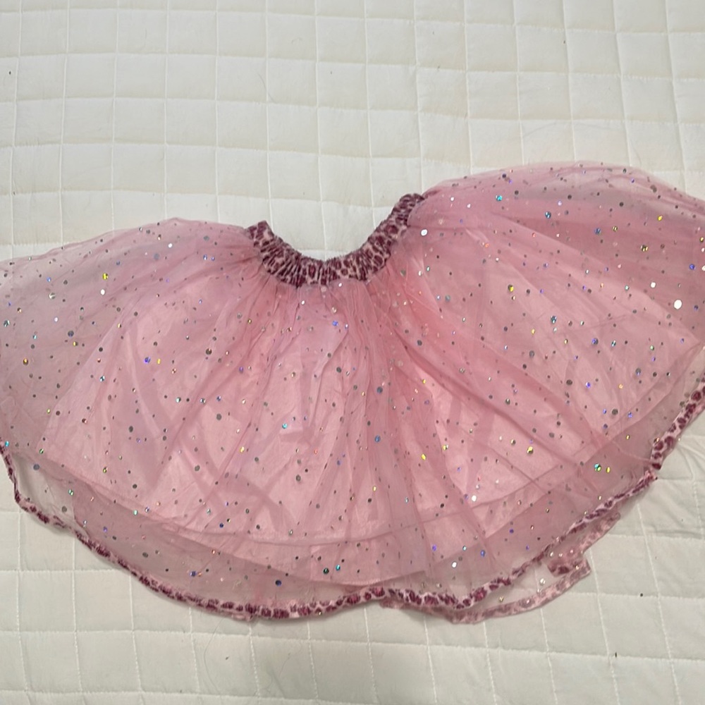 Pink sparkly ballet tutu with pink leopard print on edges. Like new condition.